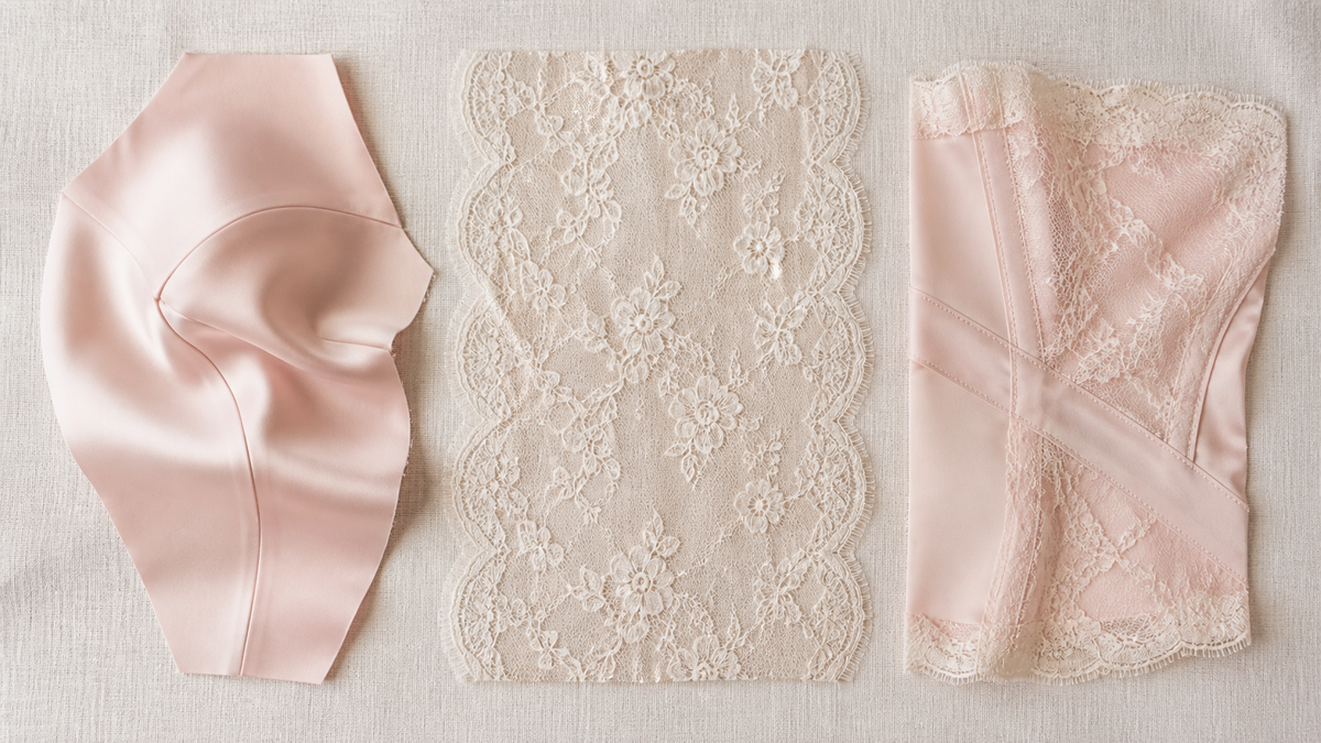 Flat lay of a moulded silk cup panel, a single sheer lace panel and a seamed lace and satin piece on cream linen