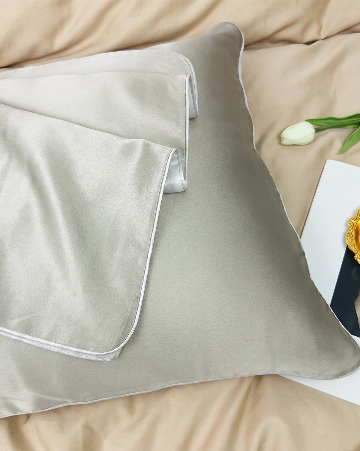 Darette Night Shift Silk Pillowcase in Sage - front view on a soft studio backdrop