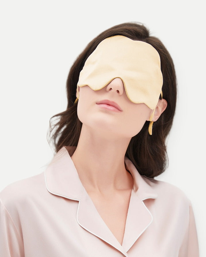 Darette Lights Out Silk Eye Mask in Champagne - front view on a soft studio backdrop