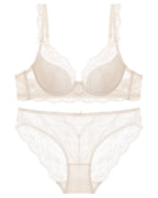 Flat lay of the Darette Low Key Lace Set in Ivory on a plain surface