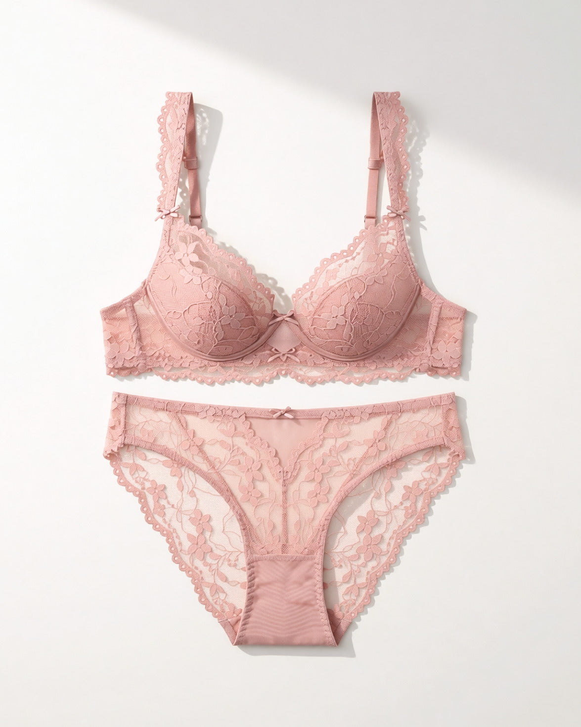 Flat lay of the Darette Low Key Lace Set in Blush on a plain surface