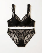 Flat lay of the Darette Low Key Lace Set in Noir on a plain surface