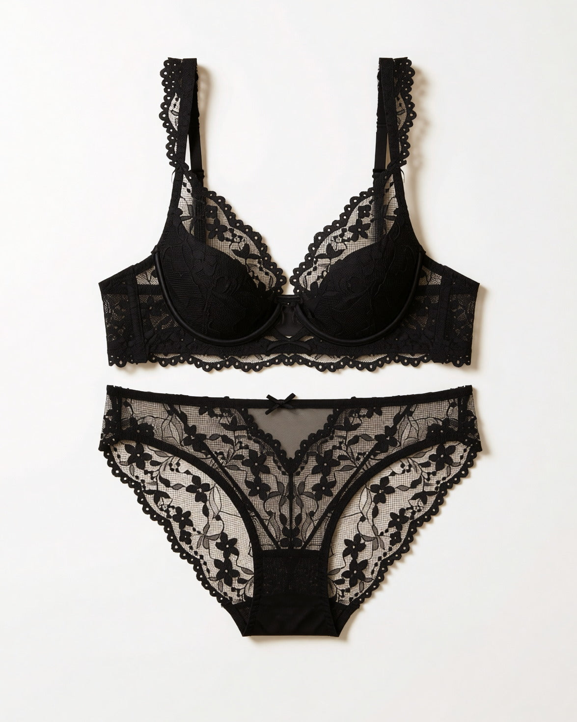 Flat lay of the Darette Low Key Lace Set in Noir on a plain surface