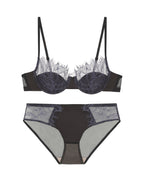 Flat lay of the Darette Second Skin Lace Set in Noir on a plain surface