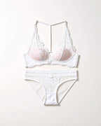 Flat lay of the Darette Open Secret Halter Set in Ivory on a plain surface