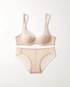Flat lay of the Darette Good Habit Lace Set in Champagne on a plain surface