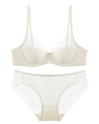 Flat lay of the Darette Good Habit Lace Set in Blush on a plain surface