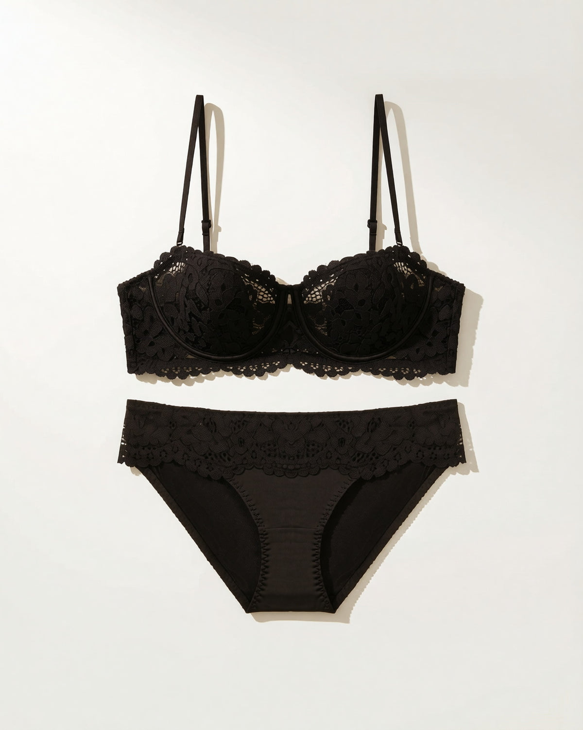 Flat lay of the Darette Half Truth Half-Cup Set in Noir on a plain surface