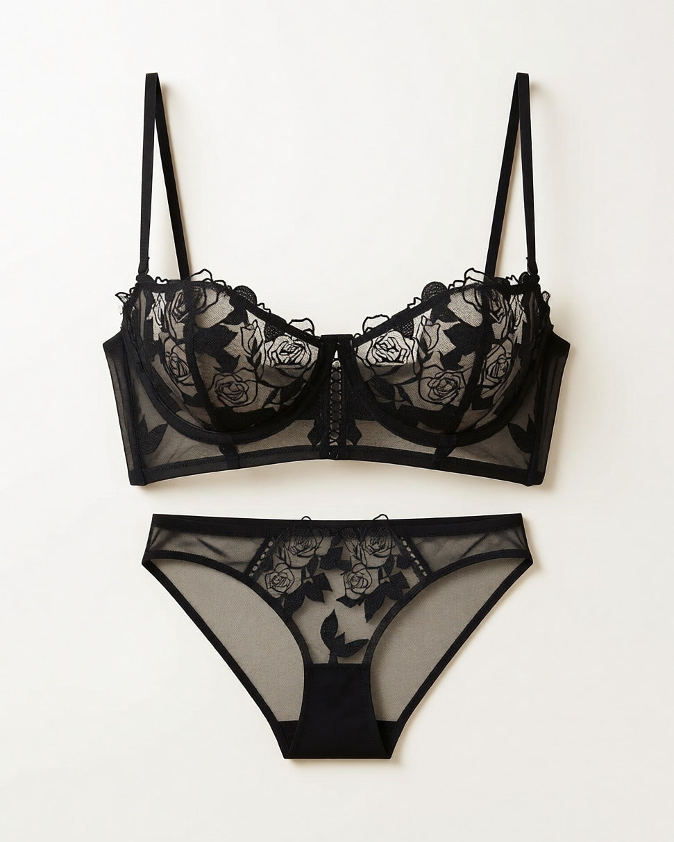 Flat lay of the Darette Slow Burn Lace Set in Noir on a plain surface