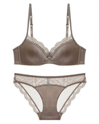 Flat lay of the Darette Golden Hour Satin-Lace Set in Mocha on a plain surface