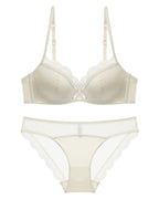 Flat lay of the Darette Golden Hour Satin-Lace Set in Ivory on a plain surface