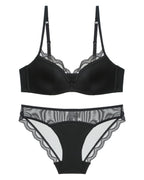 Flat lay of the Darette Golden Hour Satin-Lace Set in Noir on a plain surface