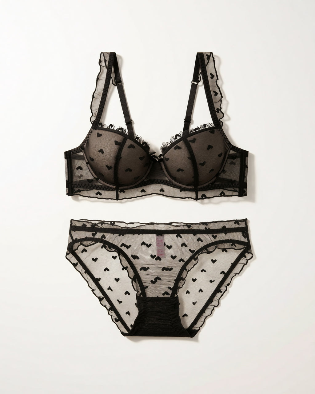 Flat lay of the Darette Soft Spot Lace Set in Noir on a plain surface