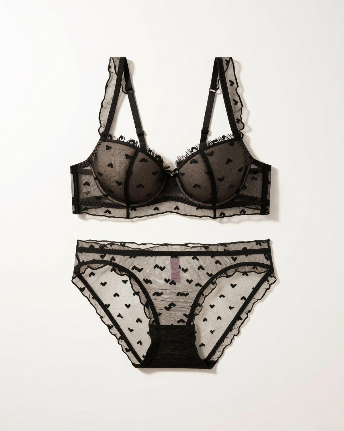 Flat lay of the Darette Soft Spot Lace Set in Noir on a plain surface
