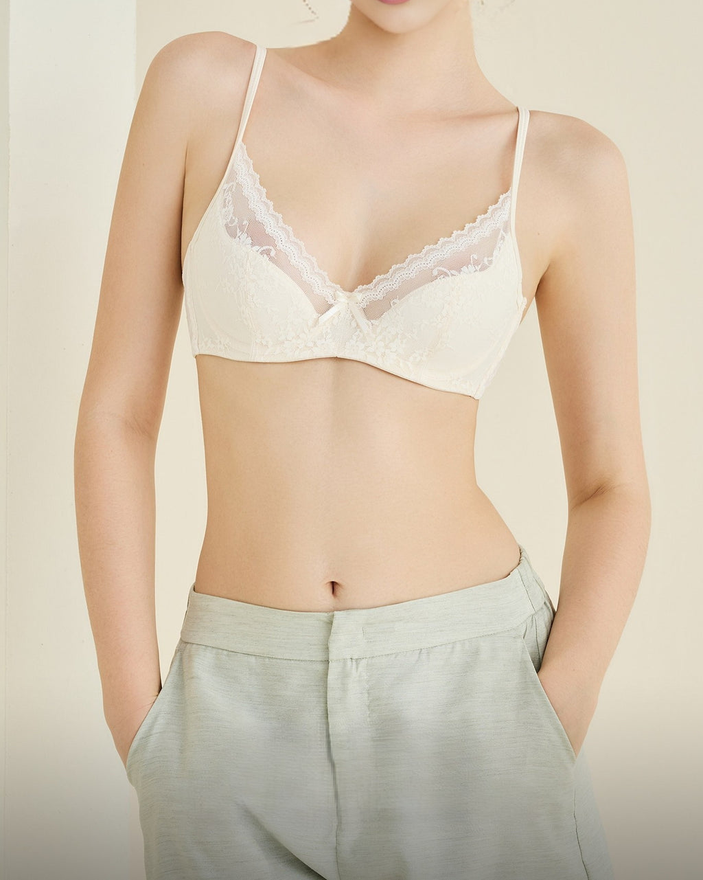 Model wearing the Darette Deep End Plunge Set in Champagne in soft indoor light