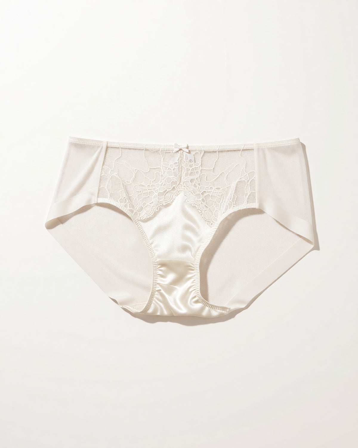 Flat lay of the Darette Bare Minimum Silk Set in Ivory on a plain surface
