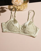 Flat lay of the Darette Bare Minimum Silk Set in Sage on a plain surface