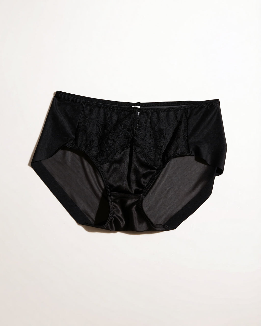 Flat lay of the Darette Bare Minimum Silk Set in Noir on a plain surface