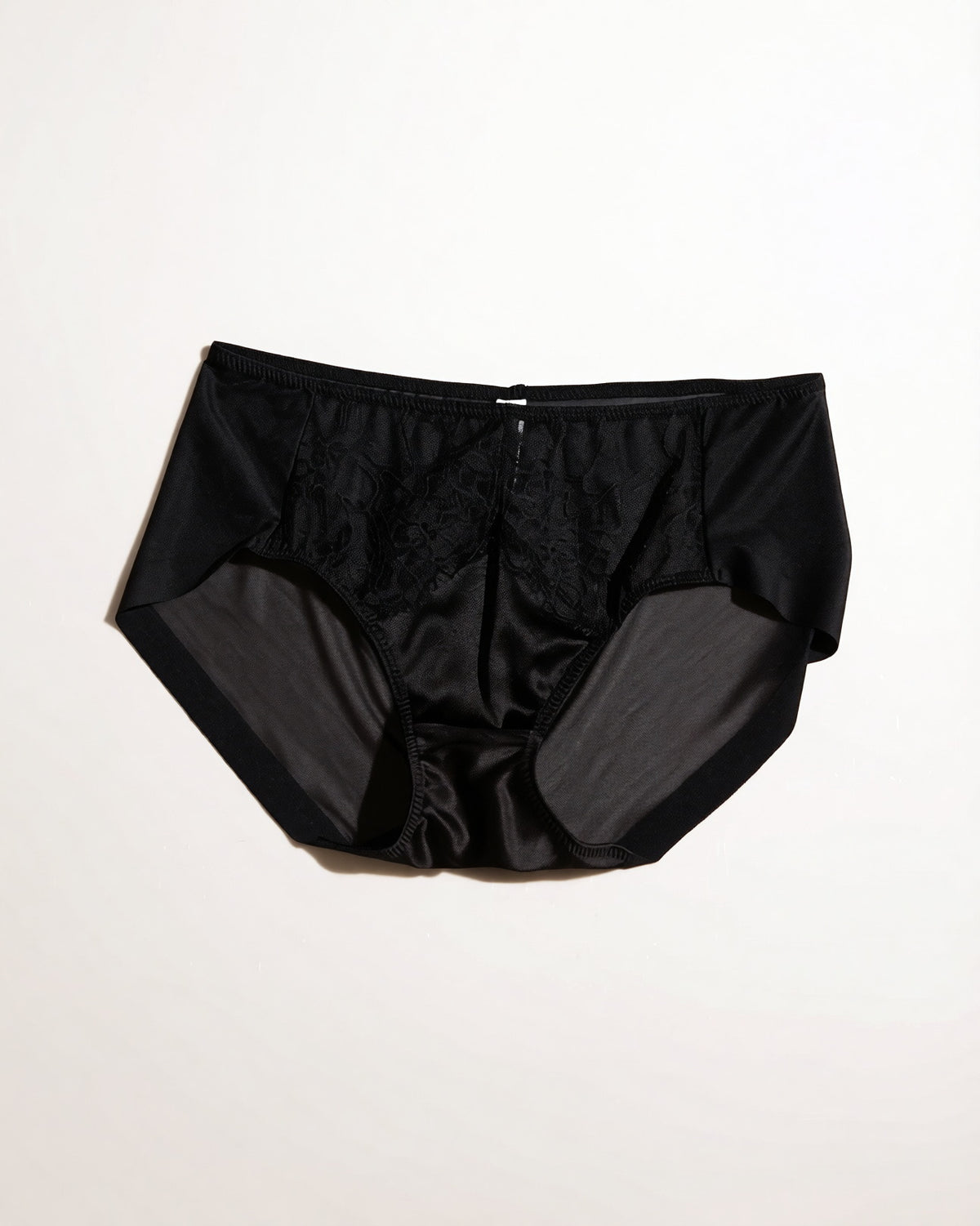 Flat lay of the Darette Bare Minimum Silk Set in Noir on a plain surface