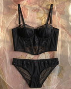 Candid lifestyle shot of the Darette After Hours Bustier Set in Noir