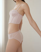 Model wearing the Darette After Hours Bustier Set in soft indoor light