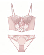 Flat lay of the Darette After Hours Bustier Set in Blush on a plain surface