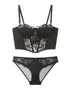 Flat lay of the Darette After Hours Bustier Set in Noir on a plain surface