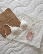 Candid lifestyle shot of the Darette Just Because Silk-Lace Set in Ivory