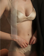 Darette Bare Minimum Silk Set in Champagne - front view of the silk and lace bra and brief with a sheer wrap across the body