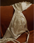 Darette Bare Minimum Silk Set - close-up of the lace bra cup on the flat-laid set