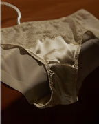 Darette Bare Minimum Silk Set - close-up of the lace brief on the flat-laid set
