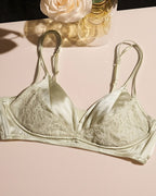 Darette Bare Minimum Silk Set in Sage - flat lay of the silk and lace bra against a floral backdrop