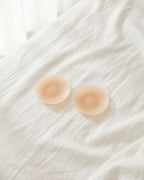 Darette Breathing Room Covers in two shades laid together on bedding to compare tones