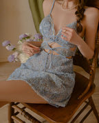 Darette Built In Slip in Sky - seated pose showing the floral lace-up front detail and short flared skirt