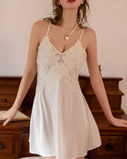 Darette Champagne Problems Satin Slip - front view standing with a pearl necklace