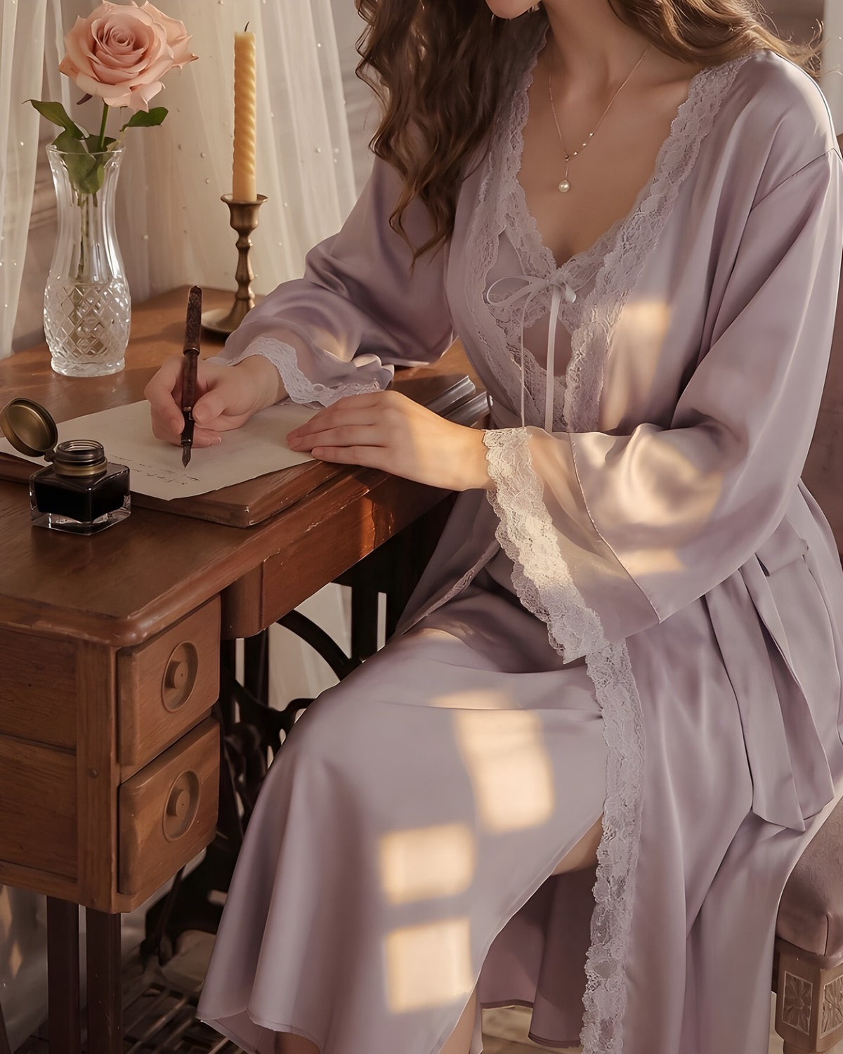 Darette Cover Story Set in Mauve - satin robe and gown, seated at an antique writing desk