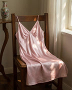 Darette Curtain Call Silk Slip in Blush - satin slip dress draped over a wooden chair
