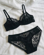 Darette Deep End Plunge Set in Noir - flat lay of the bra and panty set on the bed