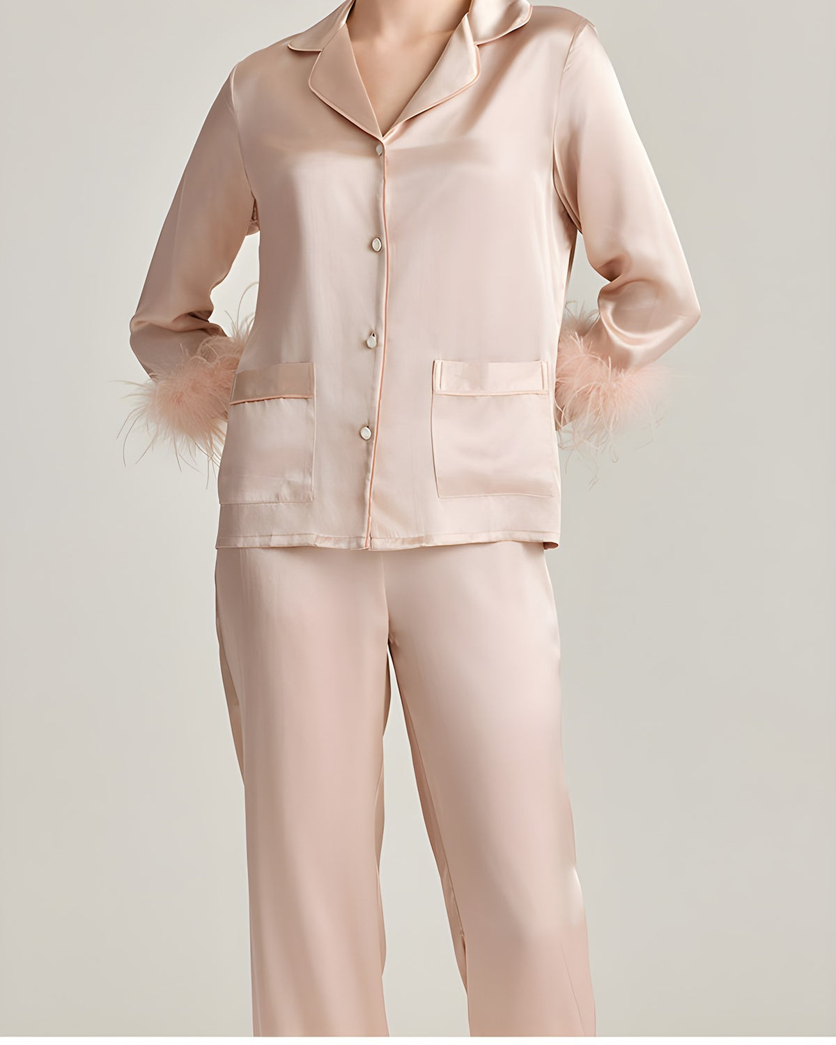 Close-up of the Darette Feather Weight Silk Set in Blush - feather-trimmed cuff on the satin pajama top