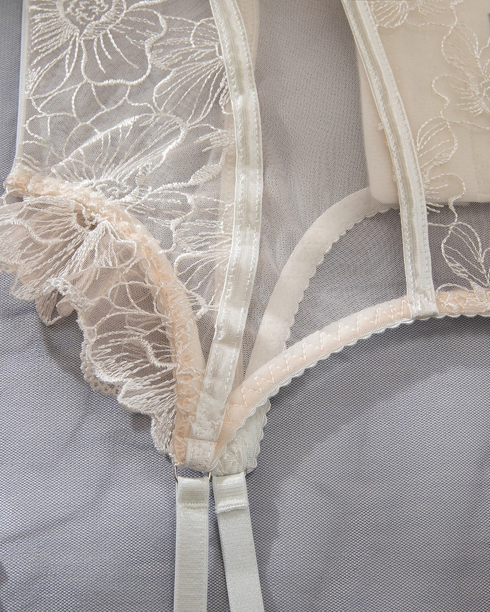 Close-up of the Darette Fine Print Garter Set in Ivory - floral lace panel and garter strap detail