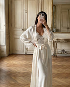 Darette First Light Set in Champagne - belted satin robe with lace cuffs over the matching lace-trimmed slip, mirror selfie in a room with pale panelled walls and a herringbone wood floor