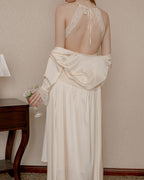 Back view of the Darette First Light slip in Champagne - open halter back with lace trim, robe slipping off the arms