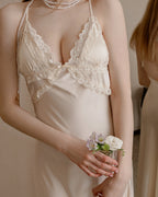 Close-up of the Darette First Light slip in Champagne - scalloped lace cups and thin halter straps