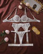 Darette Full Bloom Embroidered Set in Ivory laid flat with roses, showing bra and garter belt