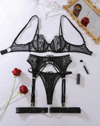 Darette Full Bloom Embroidered Set in Noir laid flat with roses, showing bra and garter belt