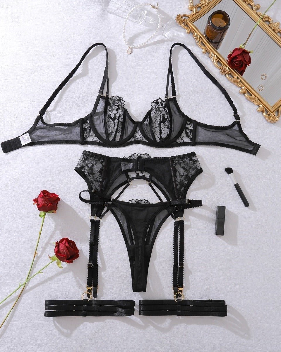 Darette Full Bloom Embroidered Set in Noir laid flat with roses, showing bra and garter belt