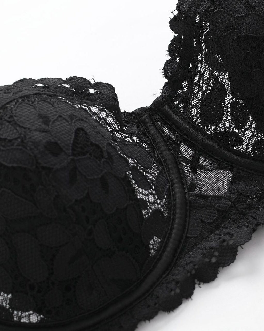Close-up side view of the Darette Half Truth Half-Cup Set bra in Noir, showing the scalloped lace edge