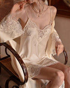 Darette Lash Line Lace Slip in Champagne - seated in a cane chair with a matching robe draped over the shoulders