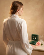 Back view of the Darette Late Start Robe in Ivory - satin robe draped open, styled with a jewelry box
