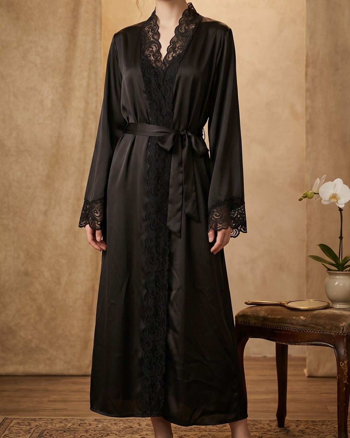 Darette Late Start Robe in Noir - satin robe with lace trim, front view with a tied sash
